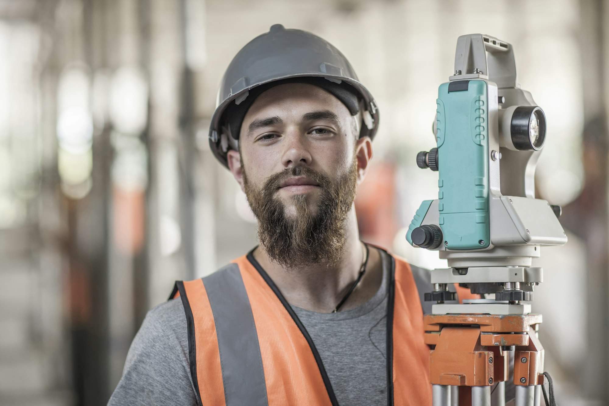 Portrait of young male surveyor on construction site